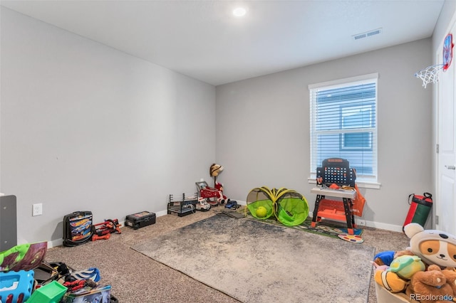 game room featuring carpet flooring, visible vents, and baseboards