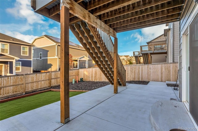 view of patio / terrace with a residential view, a fenced backyard, and stairway