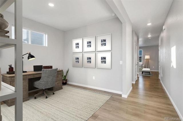 office featuring baseboards, light wood-type flooring, and recessed lighting