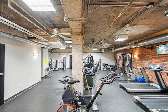 1801 Wynkoop St Unit 208, Denver, CO 80202 - gym featuring baseboards, a ceiling fan, and brick wall