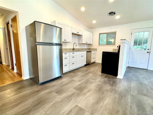 6040 W Elmhurst Dr, Littleton, CO 80128 - kitchen with appliances with stainless steel finishes, white cabinetry, lofted ceiling, light countertops, and recessed lighting