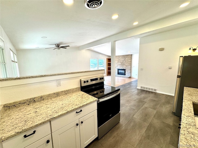 6040 W Elmhurst Dr, Littleton, CO 80128 - kitchen featuring appliances with stainless steel finishes, a ceiling fan, lofted ceiling, white cabinets, and light stone counters