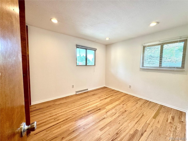 6040 W Elmhurst Dr, Littleton, CO 80128 - unfurnished room featuring light wood finished floors, a textured ceiling, and recessed lighting
