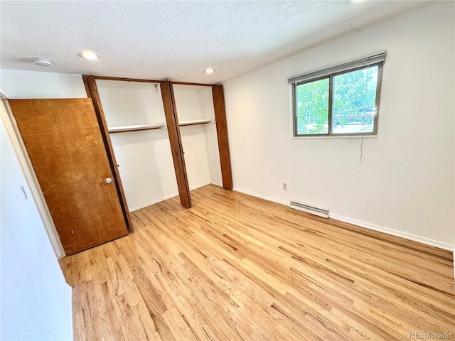 6040 W Elmhurst Dr, Littleton, CO 80128 - unfurnished bedroom featuring light wood-style floors, recessed lighting, and a textured ceiling