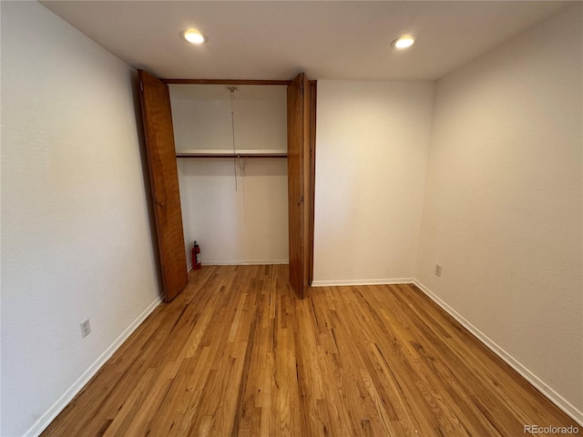 6040 W Elmhurst Dr, Littleton, CO 80128 - unfurnished bedroom featuring light wood-type flooring, a closet, and recessed lighting