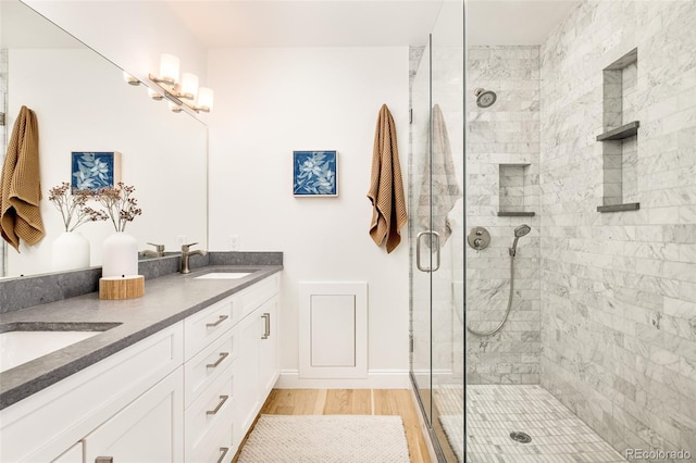 bathroom with vanity, wood-type flooring, and walk in shower