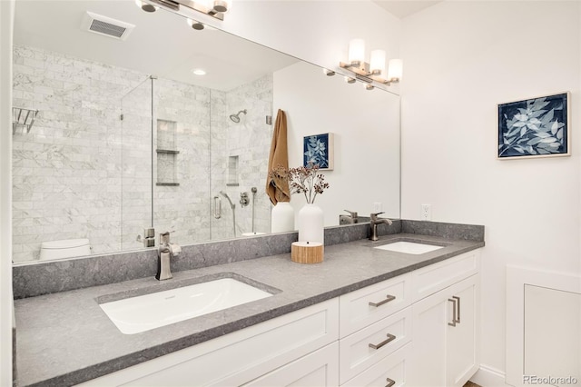 bathroom featuring vanity, toilet, and walk in shower