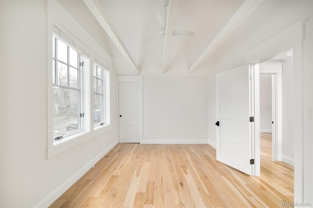 unfurnished room with beam ceiling and hardwood / wood-style flooring