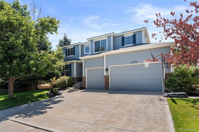 16896 E Maplewood Dr, Aurora, CO 80016 - view of front of property featuring concrete driveway, a garage, and stone siding
