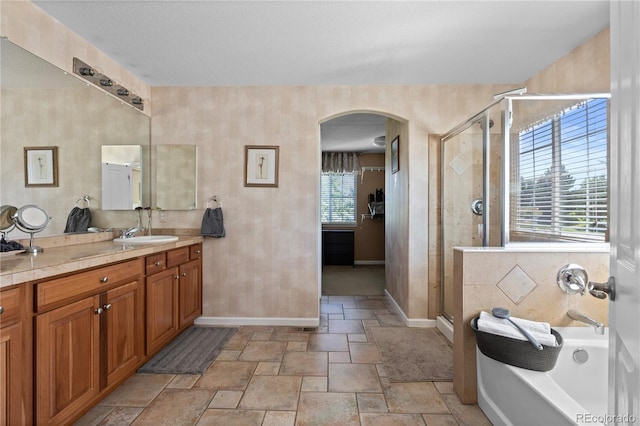 16896 E Maplewood Dr, Aurora, CO 80016 - bathroom with vanity, a garden tub, a shower stall, and stone tile flooring