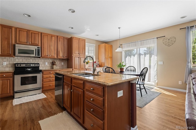 16896 E Maplewood Dr, Aurora, CO 80016 - kitchen featuring appliances with stainless steel finishes, wood finished floors, healthy amount of natural light, and recessed lighting