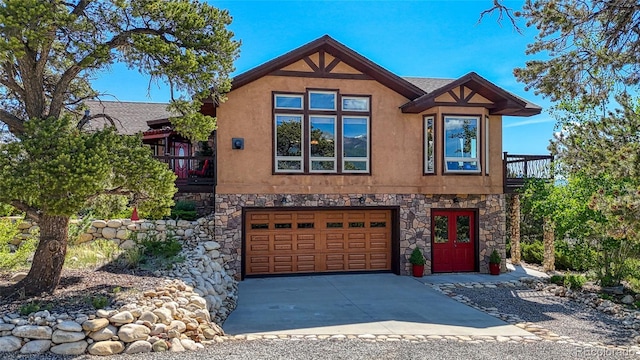12850 County Road 261k, Nathrop, CO 81236 - view of front of home with stucco siding, an attached garage, driveway, and stone siding