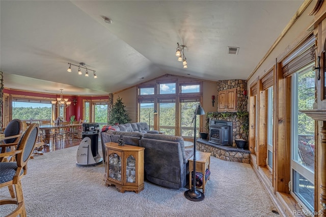 12850 County Road 261k, Nathrop, CO 81236 - living room featuring a wood stove, lofted ceiling, a chandelier, and carpet flooring