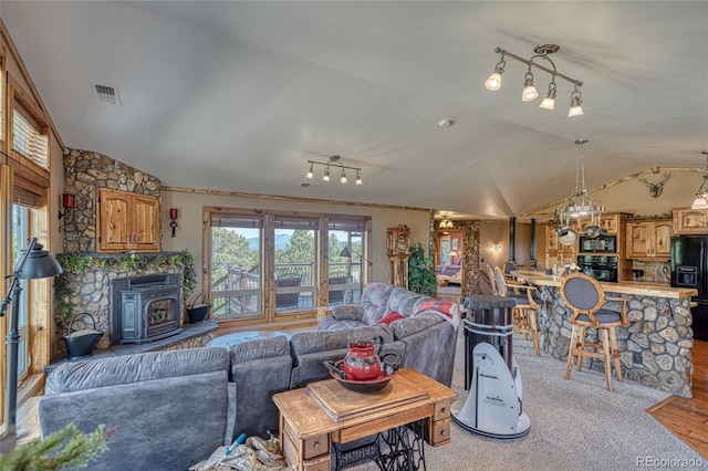 12850 County Road 261k, Nathrop, CO 81236 - living area with lofted ceiling, a wood stove, and light wood-type flooring