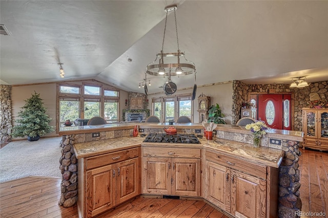 12850 County Road 261k, Nathrop, CO 81236 - kitchen with vaulted ceiling, light wood finished floors, gas stovetop, open floor plan, and brown cabinetry