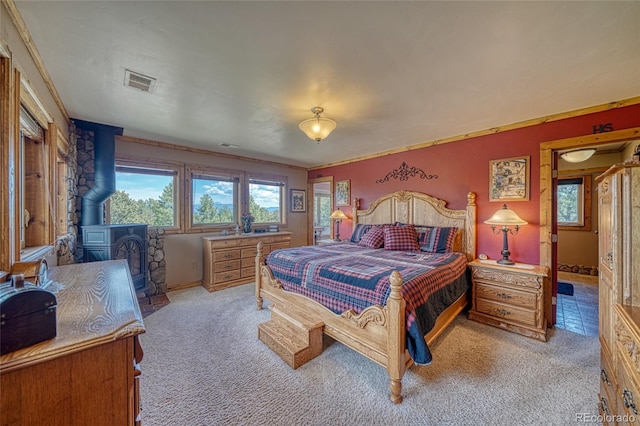 12850 County Road 261k, Nathrop, CO 81236 - bedroom with a wood stove and light carpet