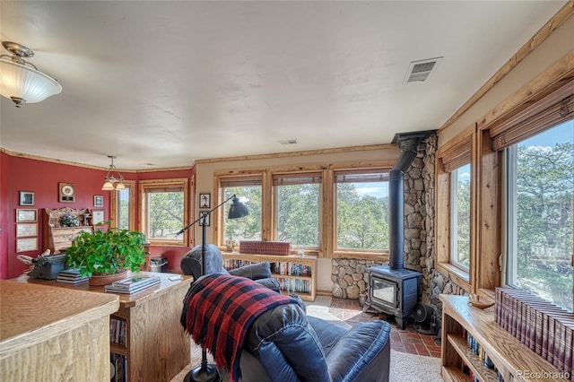 12850 County Road 261k, Nathrop, CO 81236 - living area with a wood stove, brick patterned flooring, and plenty of natural light