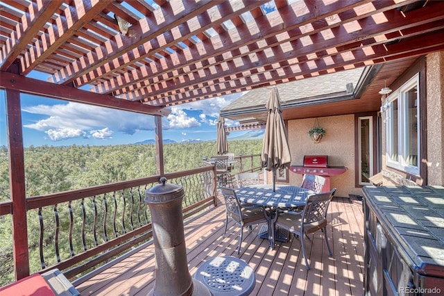 12850 County Road 261k, Nathrop, CO 81236 - wooden terrace with outdoor dining space, a pergola, and a wooded view