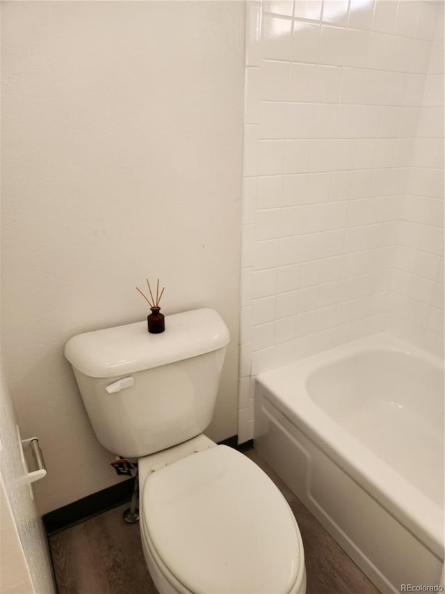 bathroom with toilet and wood finished floors