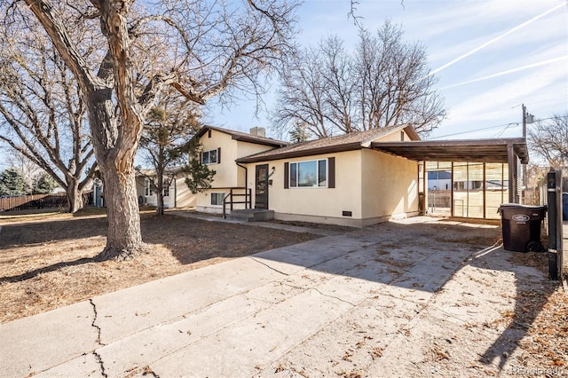 back of property with a carport