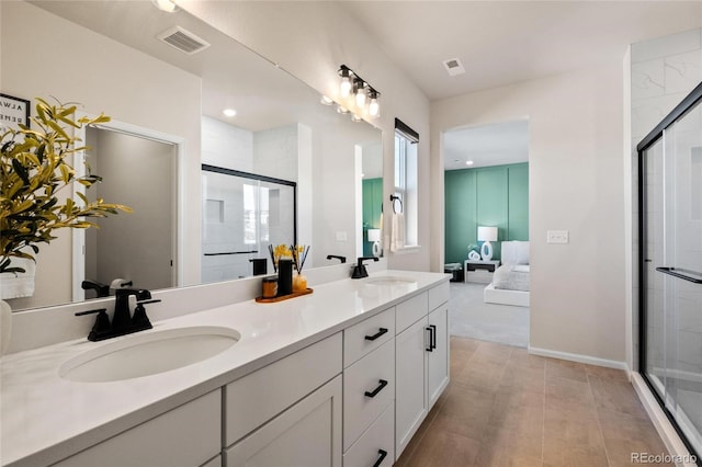 bathroom with vanity and a shower with door