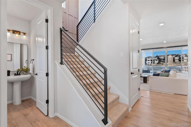 stairs featuring hardwood / wood-style floors