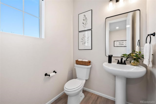 bathroom with toilet and hardwood / wood-style flooring