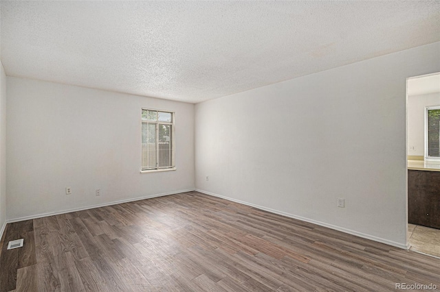 2832 S Mobile St, Aurora, CO 80013 - unfurnished room featuring wood finished floors and a textured ceiling