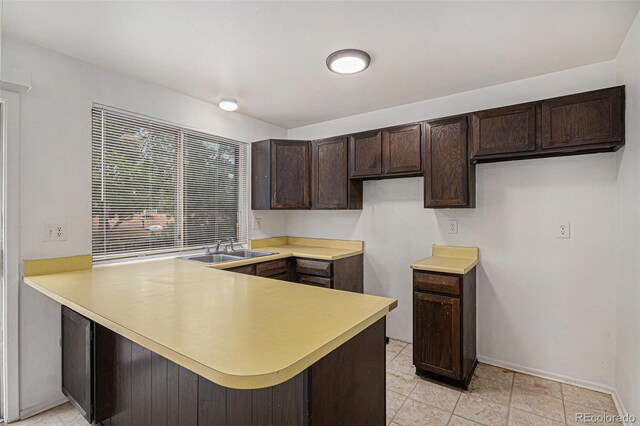 2832 S Mobile St, Aurora, CO 80013 - kitchen with dark brown cabinets, a peninsula, and light countertops