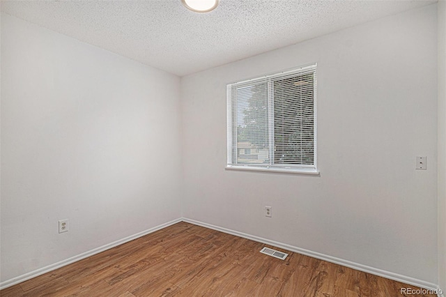 2832 S Mobile St, Aurora, CO 80013 - empty room with wood finished floors and a textured ceiling