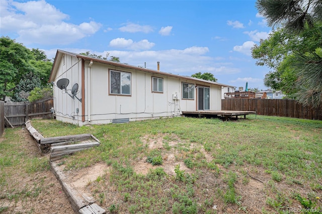 2832 S Mobile St, Aurora, CO 80013 - back of house featuring a fenced backyard, a wooden deck, and board and batten siding