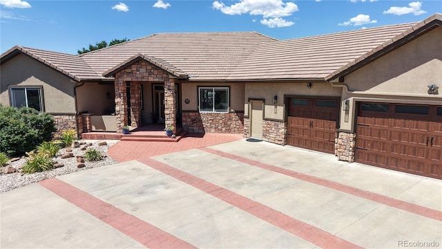 1246 Highland Pl, Erie, CO 80516 - view of front of house with stone siding, stucco siding, and a tile roof