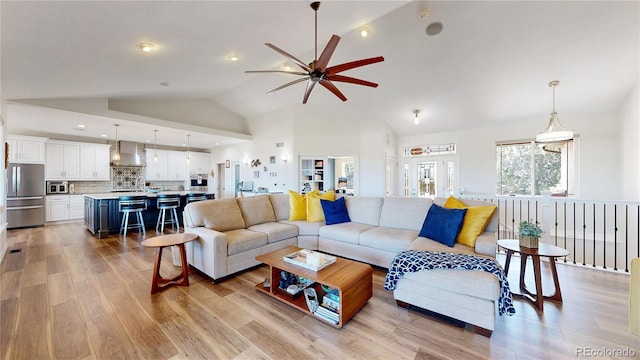 1246 Highland Pl, Erie, CO 80516 - living area featuring ceiling fan, light wood-style flooring, high vaulted ceiling, and recessed lighting