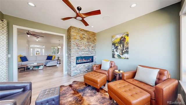 1246 Highland Pl, Erie, CO 80516 - living room with a ceiling fan, wood finished floors, a fireplace, and recessed lighting