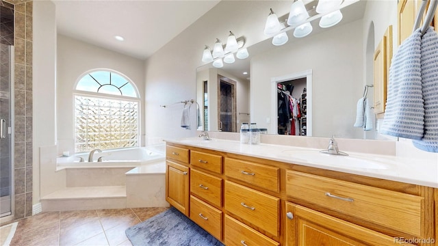 1246 Highland Pl, Erie, CO 80516 - full bathroom featuring lofted ceiling, a bath, double vanity, a shower stall, and tile patterned floors