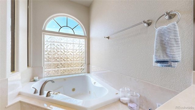 1246 Highland Pl, Erie, CO 80516 - bathroom featuring a textured wall and a jetted tub