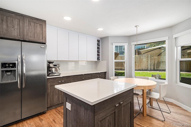 9673 Pinebrook St, Highlands Ranch, CO 80130 - kitchen with stainless steel fridge with ice dispenser, dark brown cabinetry, white cabinets, light wood-type flooring, and recessed lighting