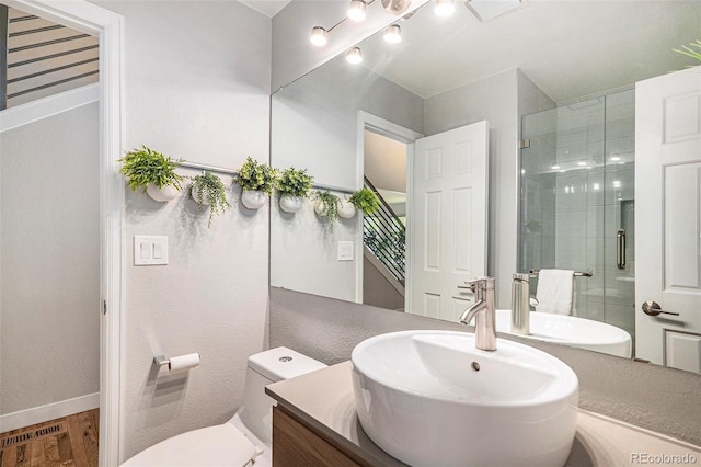 9673 Pinebrook St, Highlands Ranch, CO 80130 - bathroom featuring vanity, a shower stall, wood finished floors, and toilet