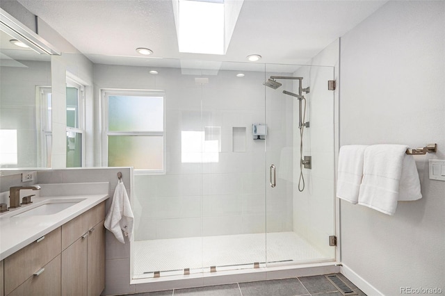 9673 Pinebrook St, Highlands Ranch, CO 80130 - full bath featuring a shower stall, vanity, baseboards, tile patterned flooring, and recessed lighting