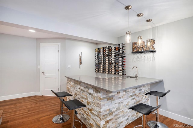 9673 Pinebrook St, Highlands Ranch, CO 80130 - indoor dry bar featuring baseboards, wood finished floors, and pendant lighting