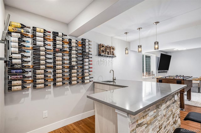 9673 Pinebrook St, Highlands Ranch, CO 80130 - wine cellar featuring light wood-style flooring, wet bar, and baseboards