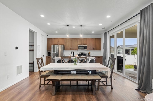 1228 Argali Dr, Severance, CO 80550 - dining space featuring recessed lighting, wood finished floors, and baseboards