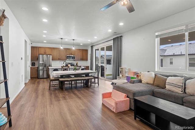 1228 Argali Dr, Severance, CO 80550 - living room with recessed lighting, ceiling fan, wood finished floors, and baseboards