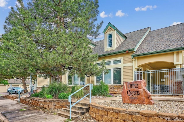9692 W Coco Cir Unit 103, Littleton, CO 80128 - view of front facade featuring roof with shingles