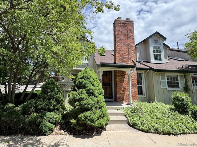 971 S Evanston Cir, Aurora, CO 80012 - view of front facade with a chimney, roof with shingles, and brick siding
