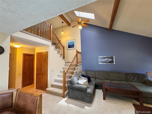 971 S Evanston Cir, Aurora, CO 80012 - carpeted living area with stairs, ceiling fan, a skylight, and a textured ceiling