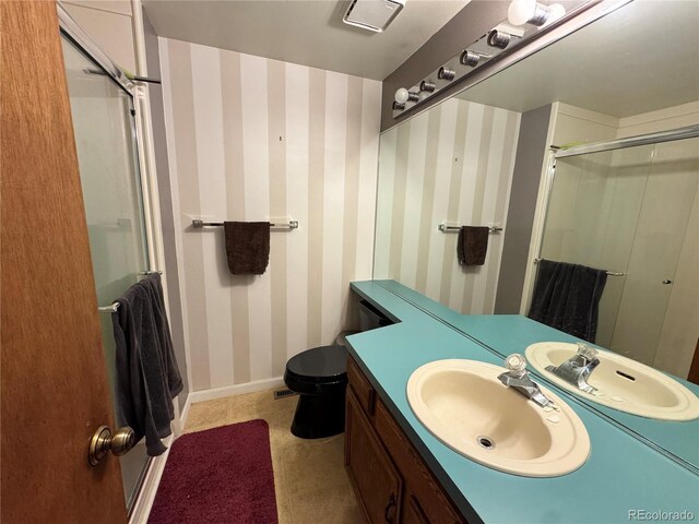 971 S Evanston Cir, Aurora, CO 80012 - bathroom featuring a stall shower, vanity, wallpapered walls, toilet, and baseboards