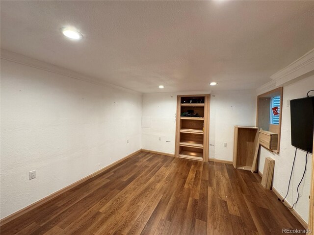 971 S Evanston Cir, Aurora, CO 80012 - unfurnished living room with ornamental molding, dark wood finished floors, recessed lighting, baseboards, and a textured ceiling