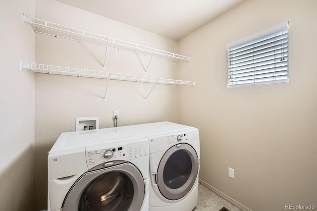laundry area featuring laundry area, baseboards, and washer and clothes dryer