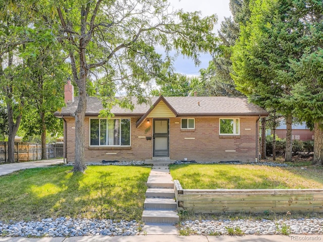1455 S Zephyr St, Lakewood, CO 80232 - view of front of property featuring brick siding, a shingled roof, and a chimney